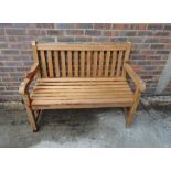 A modern hardwood garden bench, 120cm wide x 93cm high.