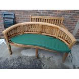 A modern hardwood garden bench with curved back, 160cm wide x 85cm high.