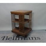 An Edwardian inlaid mahogany revolving bookcase, 50cm wide x 87cm high.