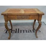 A 19th century Continental mahogany foldover card table, on cabriole supports,