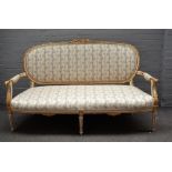 A Louis XVI style painted and gilt framed upholstered settee, 19th century, with ribbon mouldings,