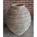 A large terracotta oil jar with ribbed body, 60cm diameter x 75cm high.