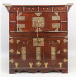 A Chinese elm dwarf side cabinet, 20th century, with pierced brass mounts,