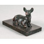 A bronze figure of a seated deer, 19th century, on a rectangular plinth base, 11.