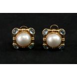 A pair of mabé pearl gold earclips, the central mabé pearls collet set to a shaped square mount,
