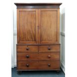 An early Victorian mahogany linen press, fitted with sliding trays,