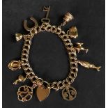 A 9ct gold double link charm bracelet su