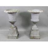 A pair of grey painted cast iron campana shape terrace urns, in classical style,