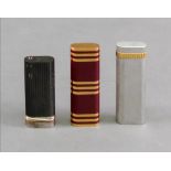 Two Cartier lighters, one enamelled in r