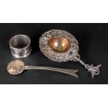 An ornate Italian silver tea strainer, w