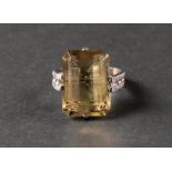 A white gold dress ring claw set with a cut cornered rectangular step cut smoky quartz between