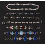 A collection of six gem and pearl- set silver bracelets of link design,