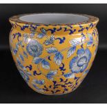 A modern Asian circular jardinière painted with flowering branches against a yellow ground,