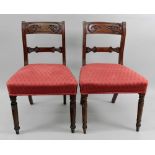 A pair of Regency carved mahogany dining