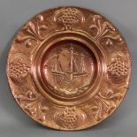 An Art Nouveau circular copper dish, the