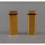 Two Cartier gold plated lighters, each w