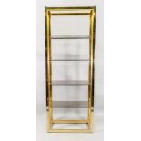 A tall gilt metal frame set of display shelves, with four smoked plate glass shelves,