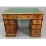 A late Victorian oak kneehole desk, the