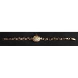 A lady’s 9ct gold wristwatch, the circular silvered dial, with Arabic numbers and baton indicators,