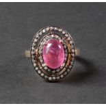 A silver gilt, cabochon ruby and diamond