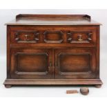 Maple & Co; an oak dwarf cabinet, of pan