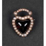 A Georgian garnet and seed pearl set brooch in the form of a heart, the cabochon garnet,