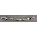 An Islamic silvered metal sword grip and