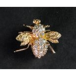 An 14ct gold brooch and diamond set broo