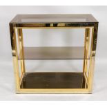 A dwarf gilt metal frame set of display shelves, with a smoked plate glass shelf,