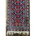 A modern Iranian rug, with repeated foliate designs, on an indigo ground, 355 x 74cm.
