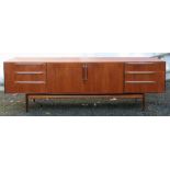 A retro McIntosh Furniture teak sideboard, circa 1960's, with a cupboard flanked by six drawers,