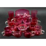 A collection of Victorian cranberry glassware including custard cups, bowl and jugs (qty).