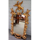 A Chippendale style upright wall mirror, the giltwood frame carved with flowers, leaves,