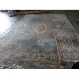 A washed Chinese carpet embossed with flowers and leaves around a