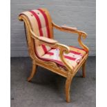 In the Manner of Henry Holland; A Regency gilt framed open armchair,