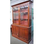 A George III mahogany bookcase cabinet, with pair of glazed doors over panelled cupboards,