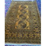 A golden Afghan rug, four large guls, 200cm x 133cm.
