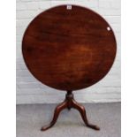 A George III and later mahogany tea table, the circular top on a vase turned pillar and tripod base,
