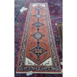 A Sarough runner, Persian, the madder field with fine indigo diamonds, ivory spandrels,