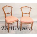 A set of six Victorian mahogany dining chairs on reeded tapering supports (6).