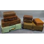 A group of mostly 20th century leather suitcases and travelling trunks,