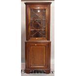 A George III style mahogany floor standing corner display cabinet on bracket feet,