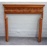 An 18th century style fire surround relief floral carved, 119cm wide x 118cm high aperture,