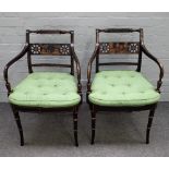 A pair of 19th century parcel gilt ebonised open armchairs, on turned splayed supports,