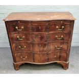 A George III style serpentine mahogany chest, the brushing slide over four long graduated drawers,