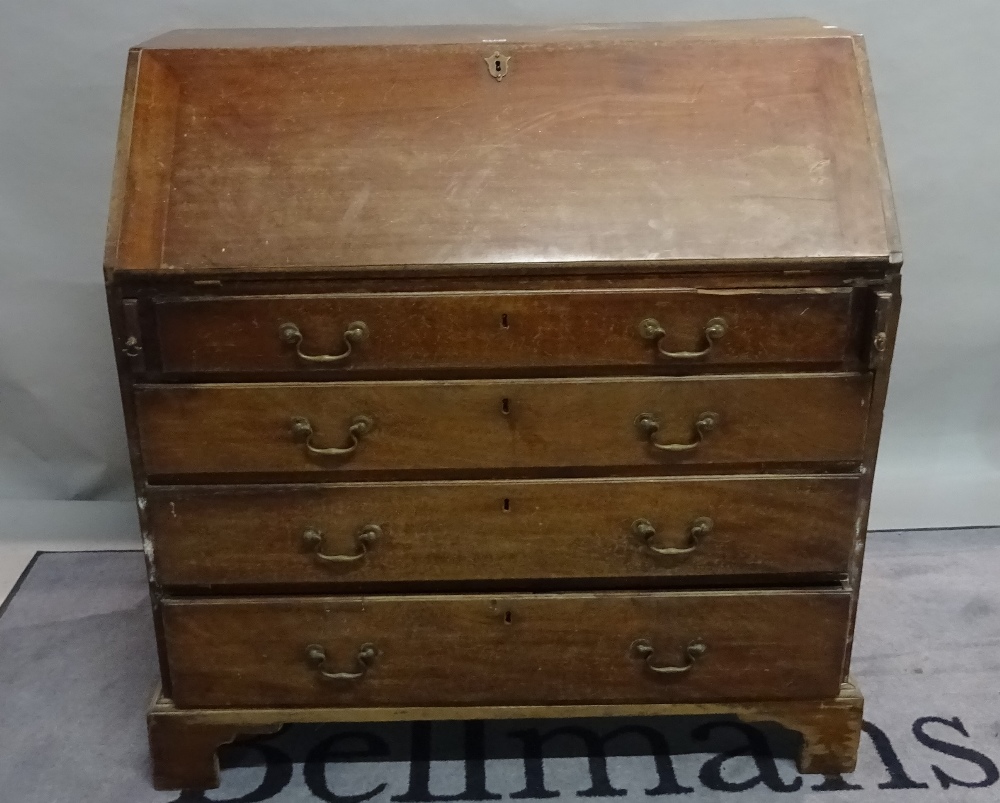 A George III mahogany bureau with four long graduated drawers on bracket feet,