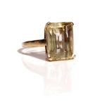 A 9ct gold ring, claw set with a rectangular step cut citrine, ring size P, gross weight 7.3 gms.