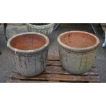 A pair of modern reconstituted stone planters with floral motif decoration,