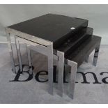 A modern chrome and black painted ash nest of three tables, the largest 58cm wide x 46cm high.