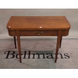 A Regency mahogany fold-over card table, with single freize drawer on tapering square supports,